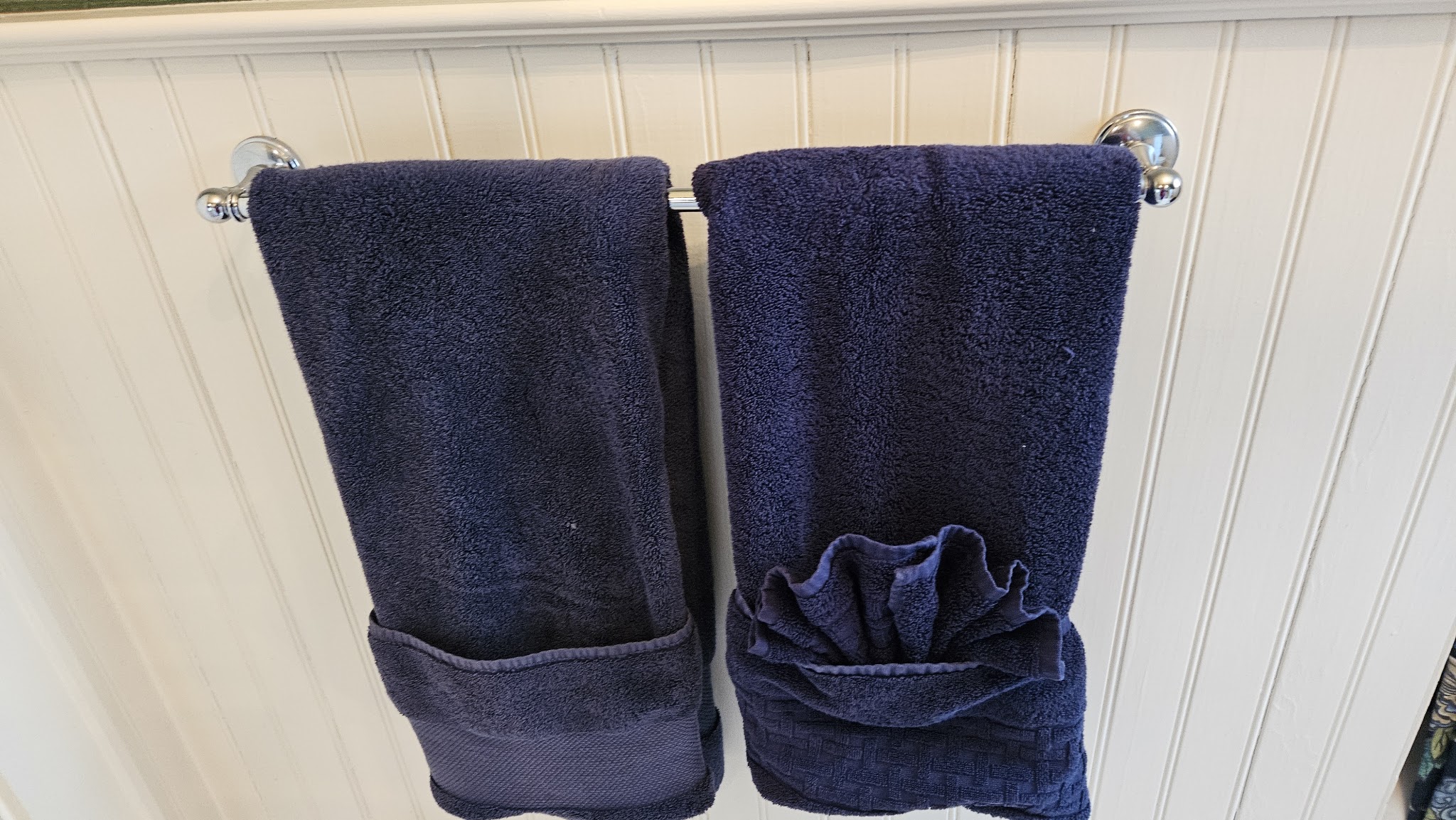 Bathroom towels folded neatly on a towel bar